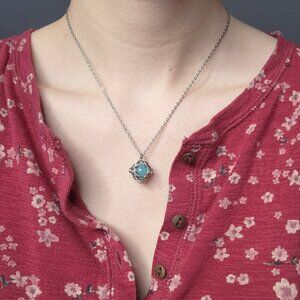 Aquamarine blue caged pearl necklace with a small silver chain